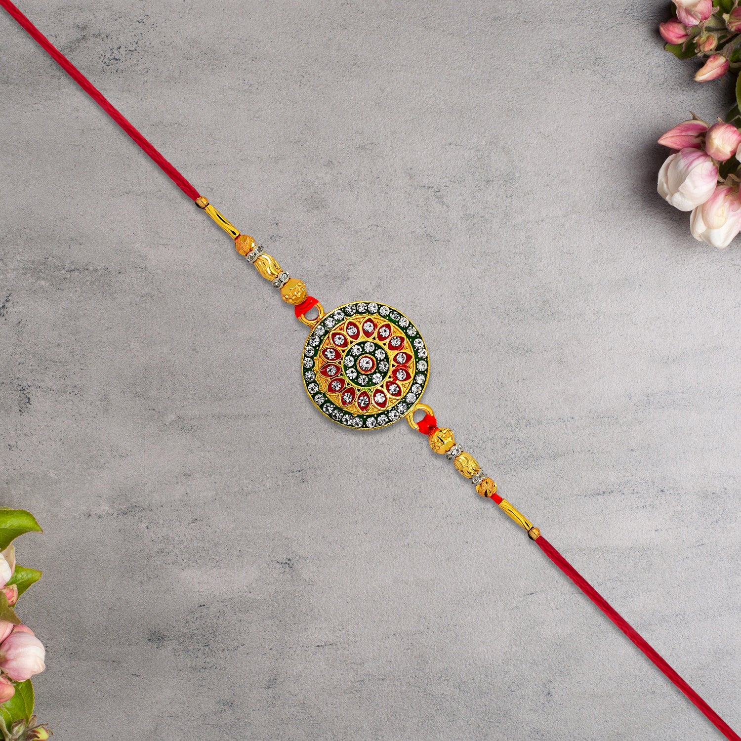 Royal Designer Rakhi With Kundan Centerpiece Red  Green Enamel Work And Golden Beads Royal Designer Rakhi With Kundan Centerpiece Red  Green Enamel Work And Golden Beads